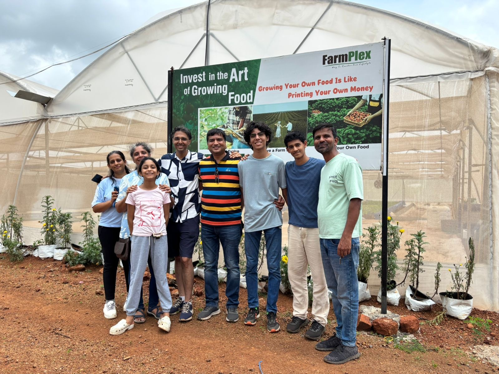 Visitors on a guided tour in front of a FarmPlex polyhouse